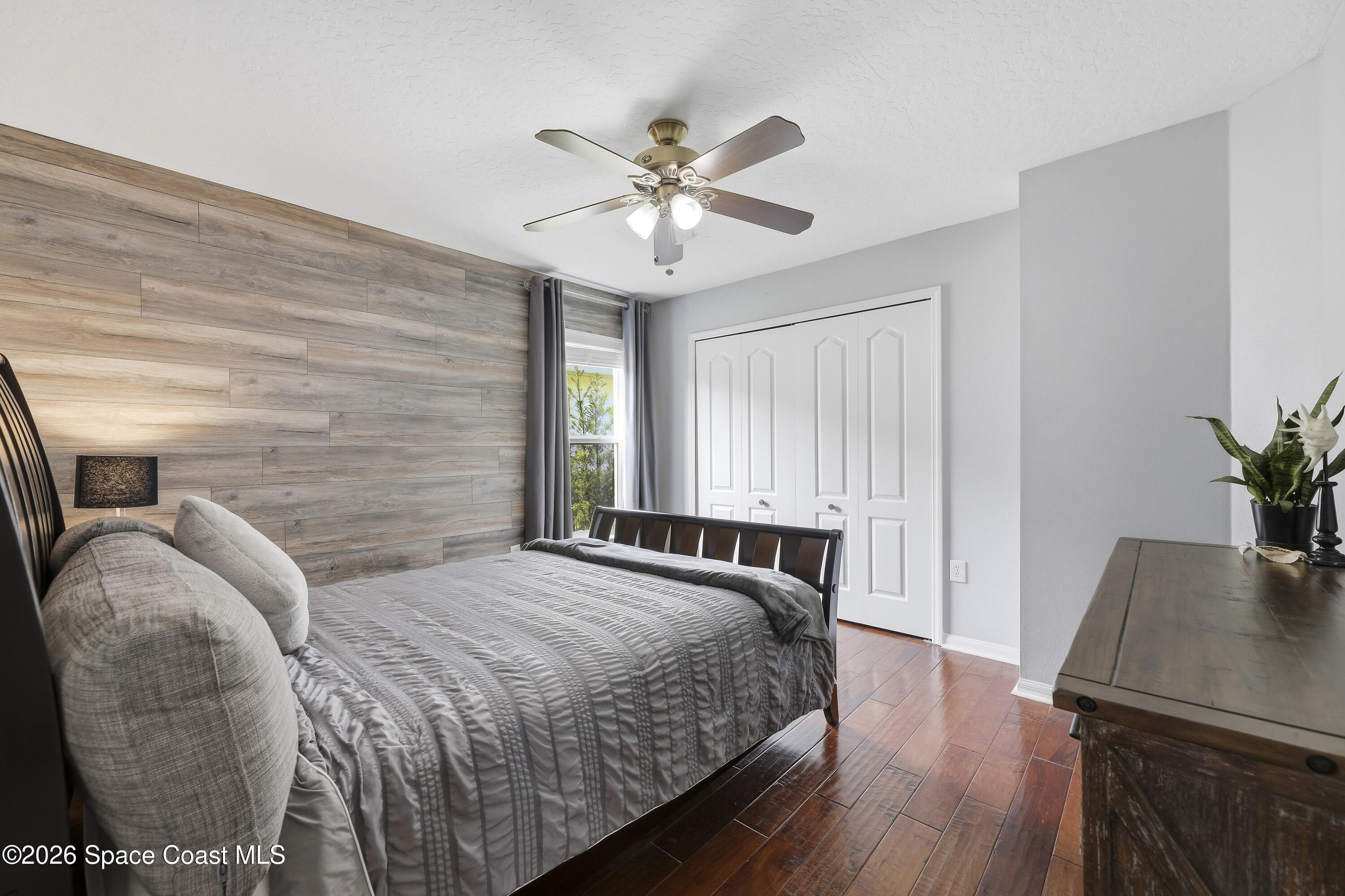 1643 Long Pine Road Melbourne, FL 32940 - Photo 38 of 63 a bedroom with a bed and a potted plant