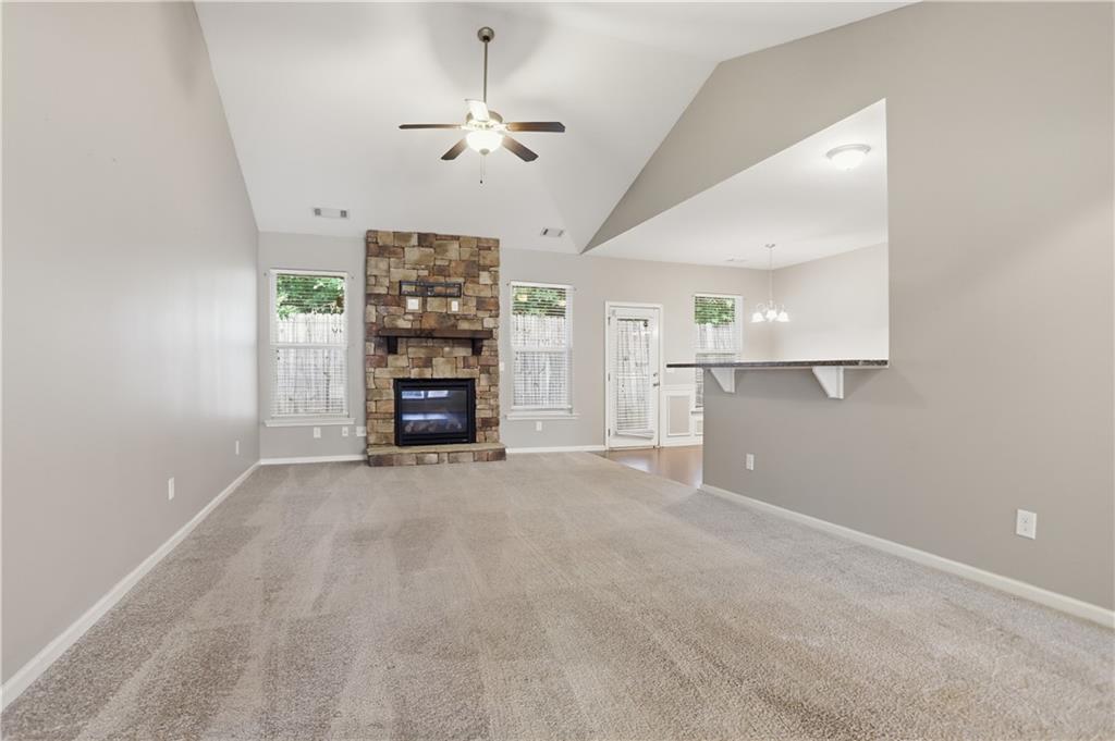 236 Manous Way Canton, GA 30115 - Photo 4 of 25 an empty room with windows fireplace and wooden floor