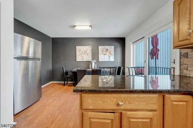 a living room with stainless steel appliances granite countertop furniture and a window