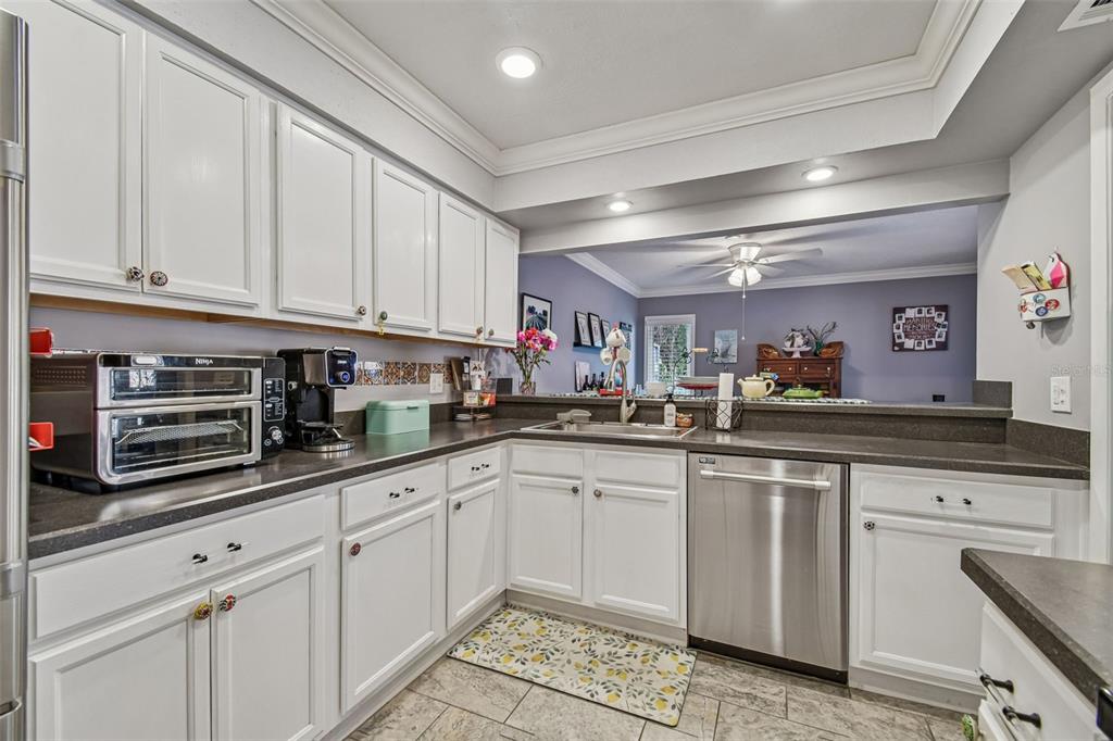 6543 Trail Ridge Drive, Unit 6543 Lakeland, FL 33813 - Photo 12 of 54 a kitchen with granite countertop white cabinets and white appliances