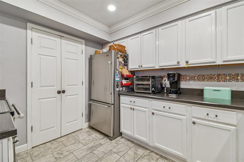 6543 Trail Ridge Drive, Unit 6543 Lakeland, FL 33813 - Photo 14 of 54 a kitchen with appliances a sink and cabinets