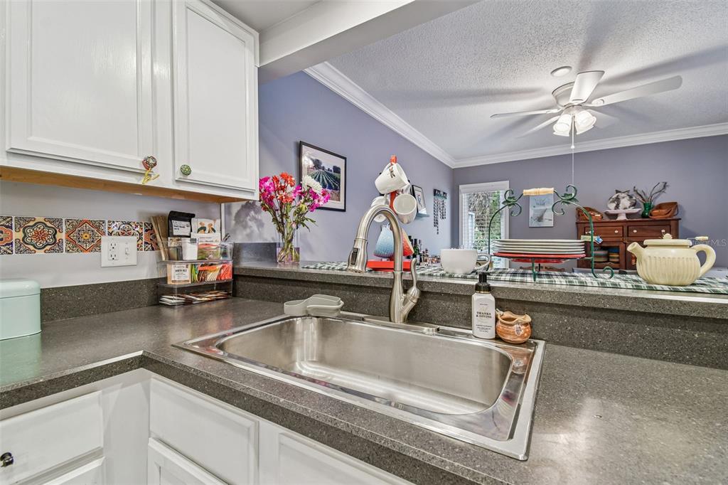 6543 Trail Ridge Drive, Unit 6543 Lakeland, FL 33813 - Photo 16 of 54 a kitchen with sink dishwasher and a stove top oven