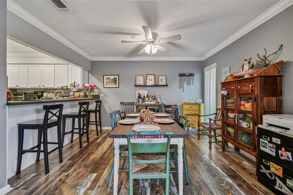 6543 Trail Ridge Drive, Unit 6543 Lakeland, FL 33813 - Photo 17 of 54 a view of a dining room with furniture and wooden floor