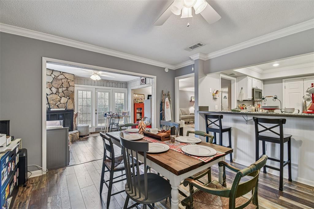 6543 Trail Ridge Drive, Unit 6543 Lakeland, FL 33813 - Photo 19 of 54 a dining room with furniture and wooden floor