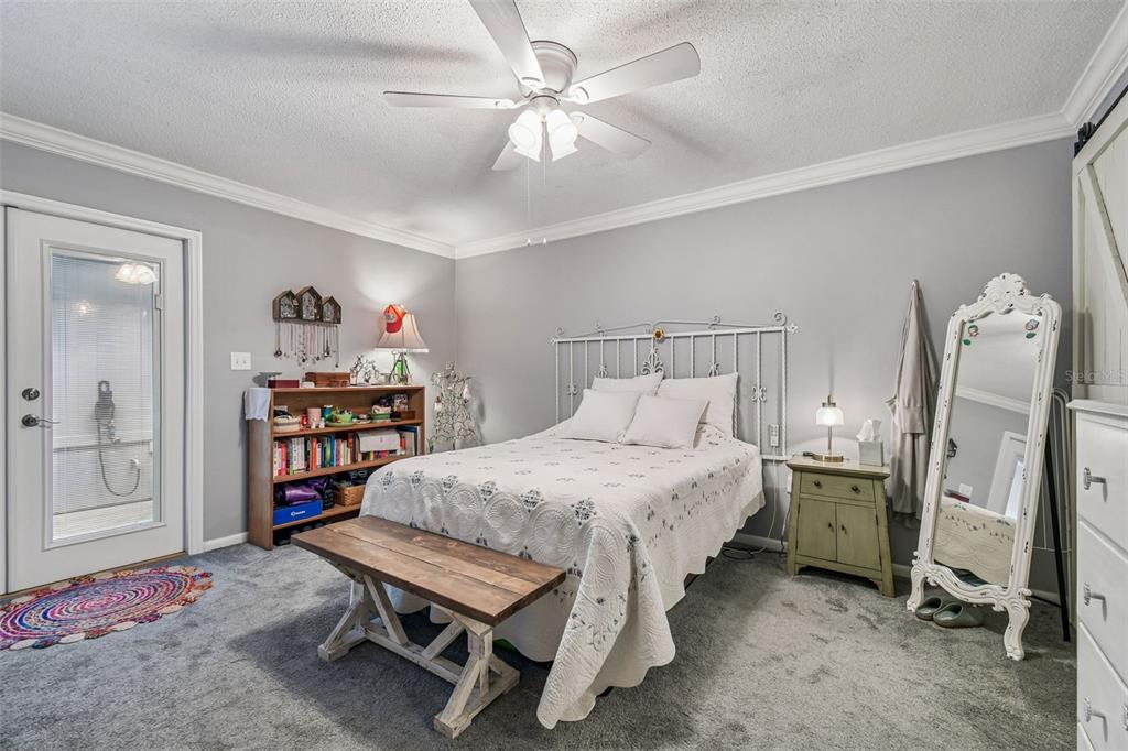 6543 Trail Ridge Drive, Unit 6543 Lakeland, FL 33813 - Photo 27 of 54 a bedroom with a bed a table and painting on the wall
