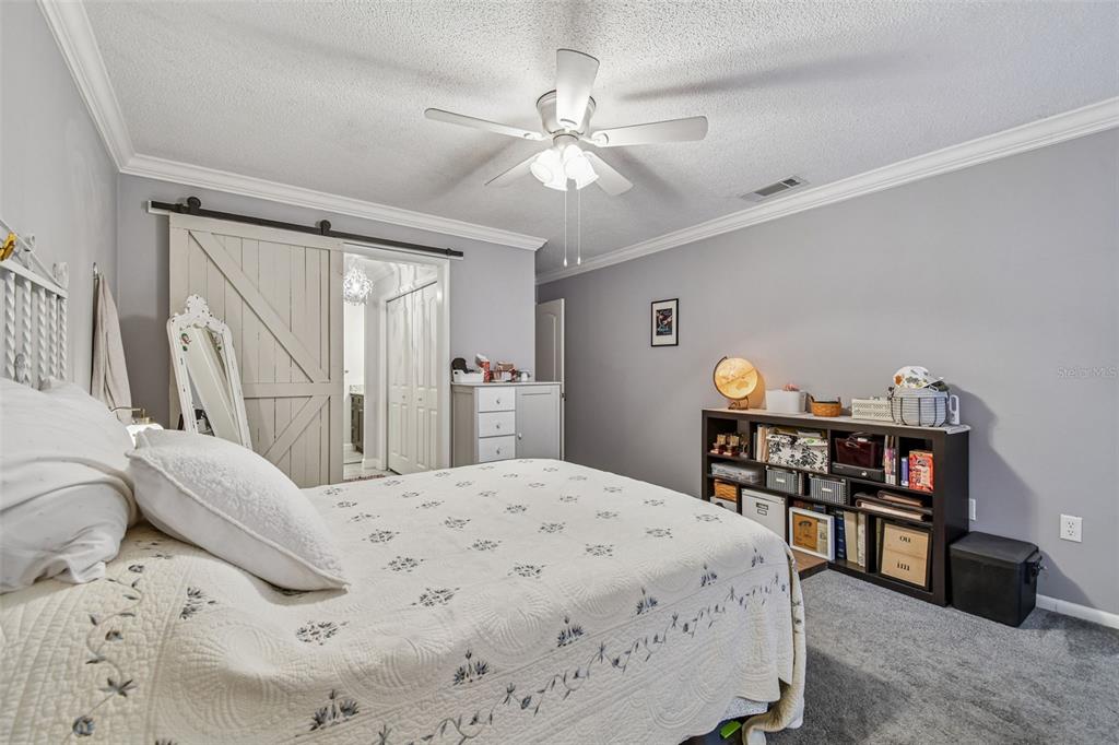 6543 Trail Ridge Drive, Unit 6543 Lakeland, FL 33813 - Photo 28 of 54 a bedroom with a bed and a book shelf