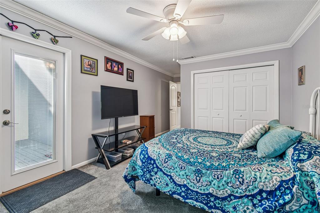 6543 Trail Ridge Drive, Unit 6543 Lakeland, FL 33813 - Photo 38 of 54 a living room with a bed and a flat screen tv