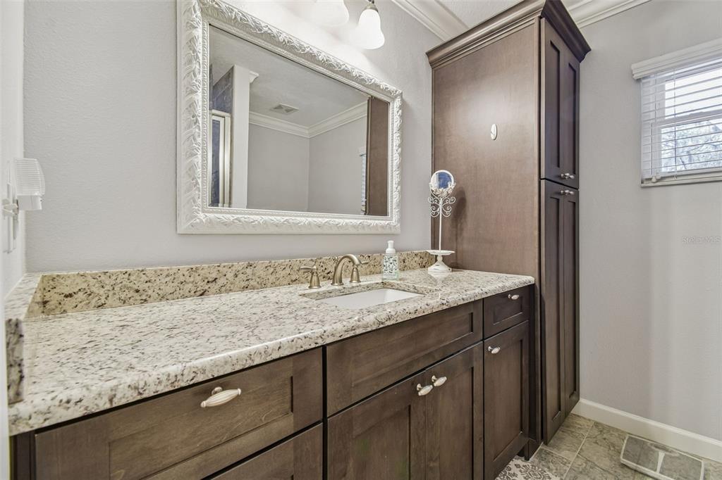 6543 Trail Ridge Drive, Unit 6543 Lakeland, FL 33813 - Photo 39 of 54 a bathroom with a granite countertop sink and a mirror