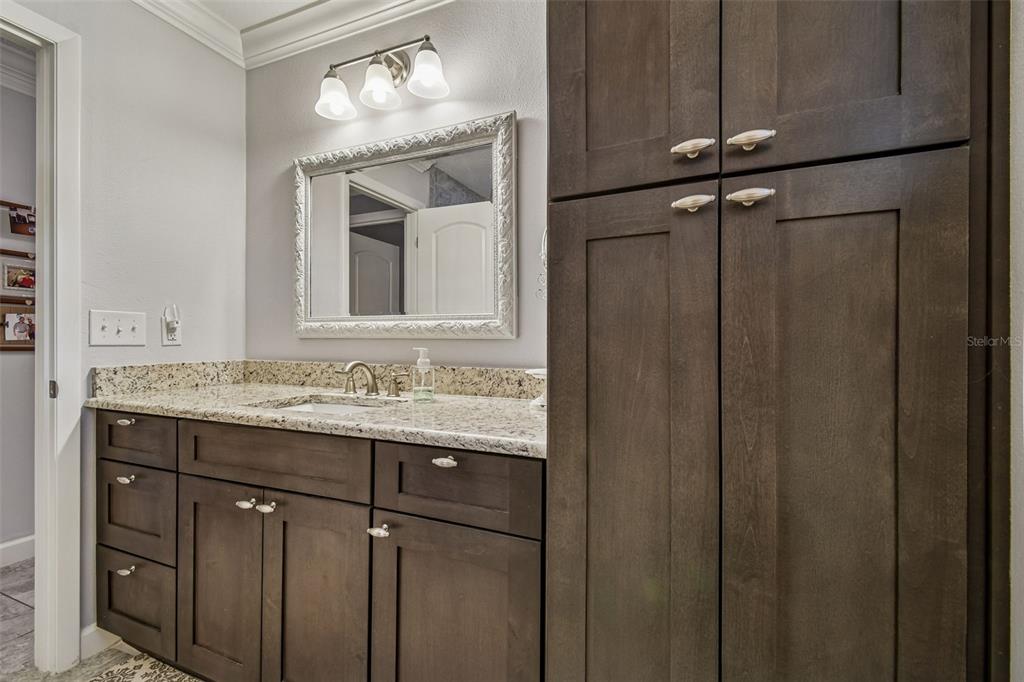 6543 Trail Ridge Drive, Unit 6543 Lakeland, FL 33813 - Photo 40 of 54 a bathroom with a granite countertop sink a mirror and a shower