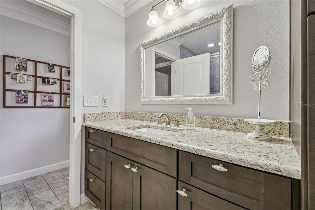 6543 Trail Ridge Drive, Unit 6543 Lakeland, FL 33813 - Photo 41 of 54 a bathroom with a granite countertop sink and a mirror