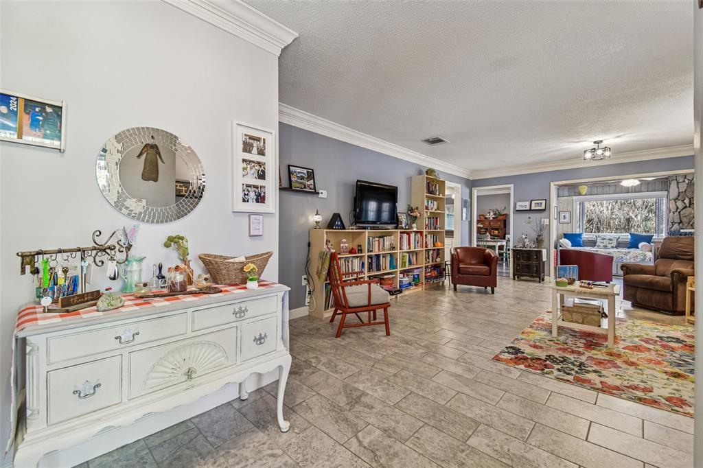 6543 Trail Ridge Drive, Unit 6543 Lakeland, FL 33813 - Photo 6 of 54 a living room with furniture a dining table and kitchen view