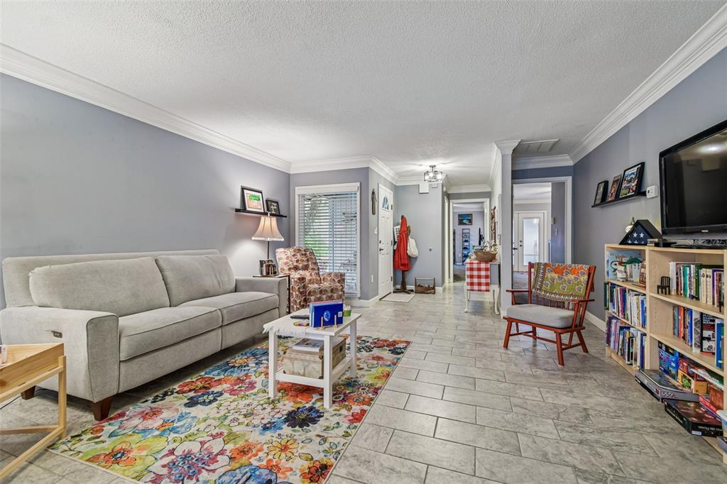6543 Trail Ridge Drive, Unit 6543 Lakeland, FL 33813 - Photo 8 of 54 a living room with furniture and a flat screen tv