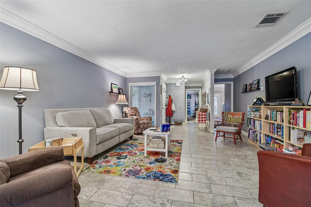 6543 Trail Ridge Drive, Unit 6543 Lakeland, FL 33813 - Photo 9 of 54 a living room with furniture and a flat screen tv