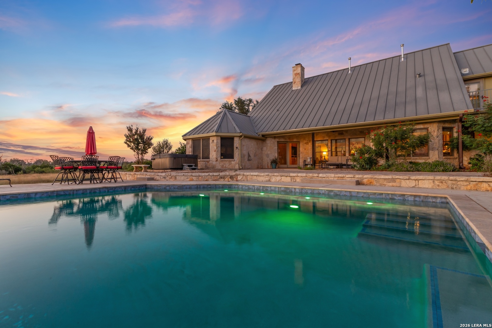 a swimming pool view with a outdoor seating