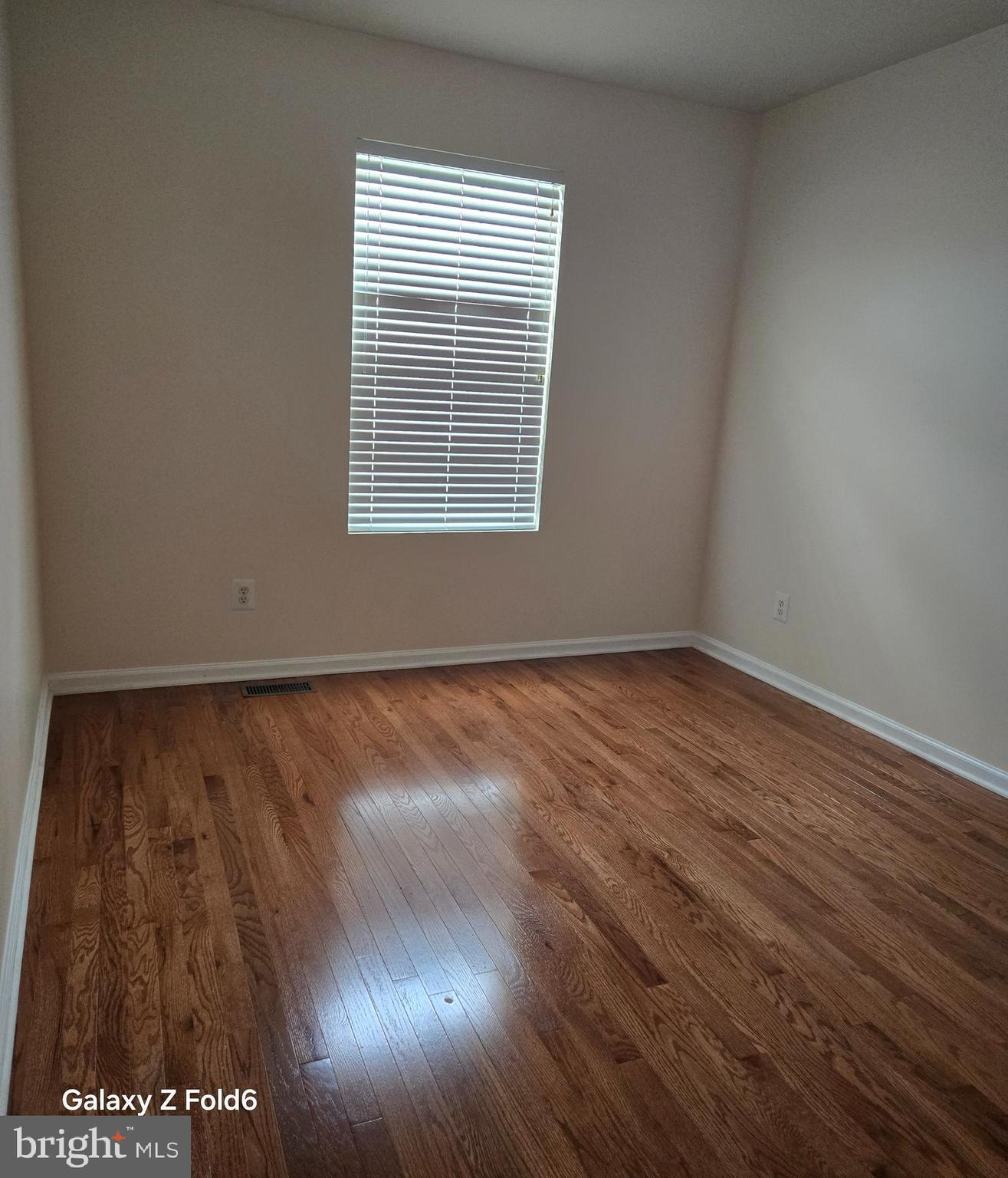 188 Joppa Farm Road Joppa, MD 21085 - Photo 21 of 28 a view of an empty room with wooden floor and a window