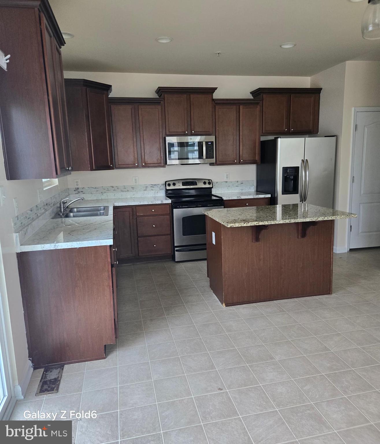 188 Joppa Farm Road Joppa, MD 21085 - Photo 6 of 28 a large kitchen with cabinets and stainless steel appliances