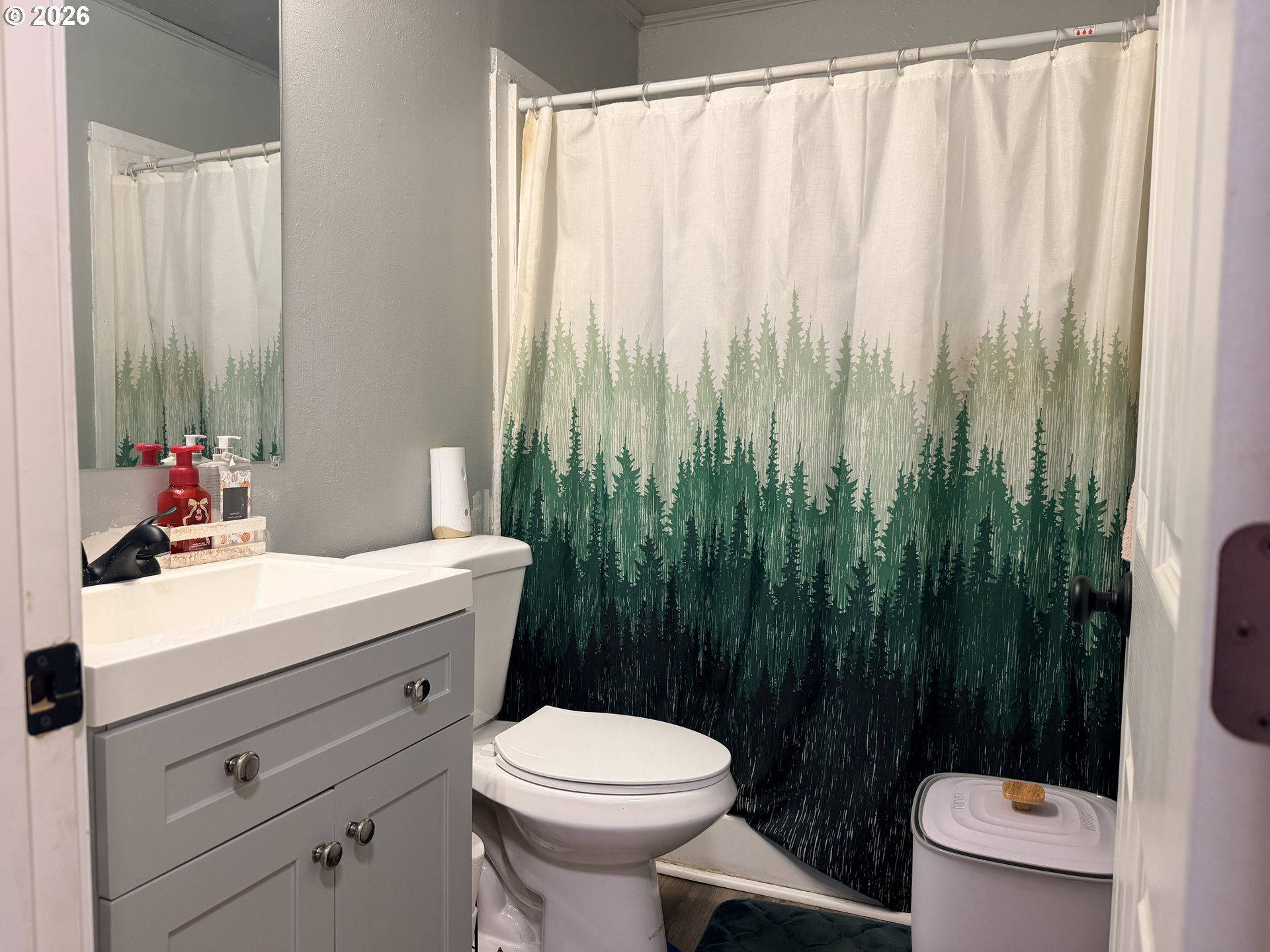 677 Southeast Moffitt Road Waldport, OR 97394 - Photo 33 of 36 a bathroom with a sink a toilet and shower curtain
