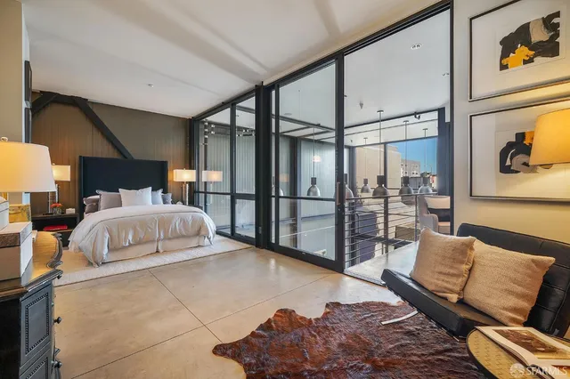 a bedroom with a large bed and a couch