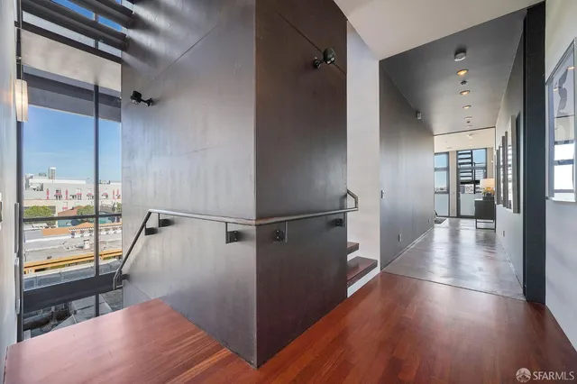 a view of a hallway view with wooden floor and staircase