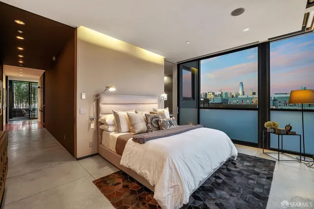 a bedroom with a large bed and a large window