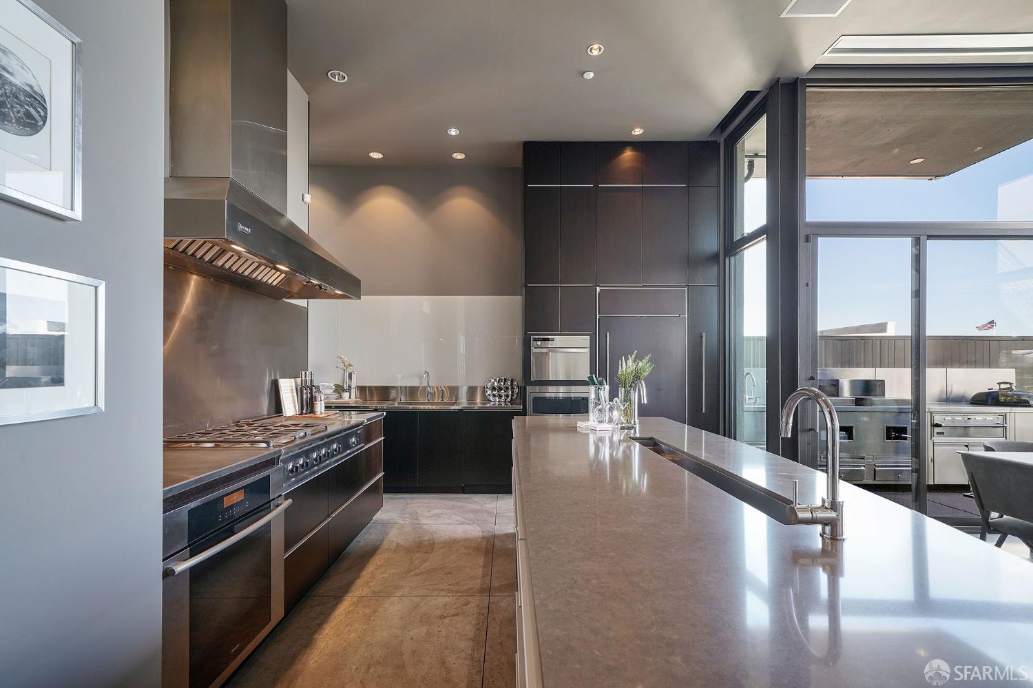 55 Sheridan San Francisco, CA 94103 - Photo 10 of 30 a kitchen with stainless steel appliances granite countertop a stove and a large window