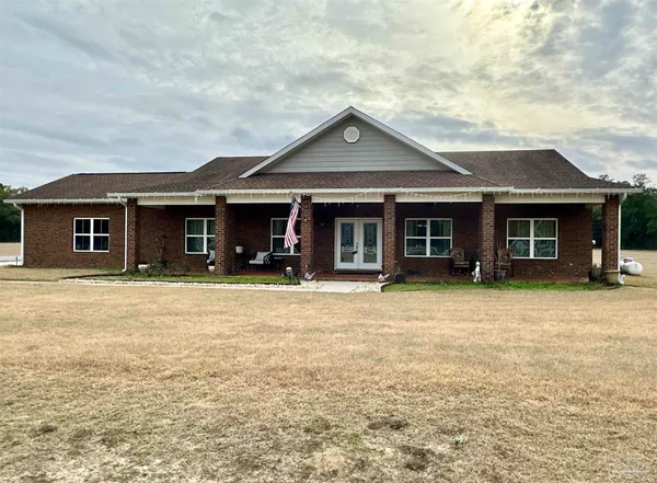 a front view of a house with yard and porch