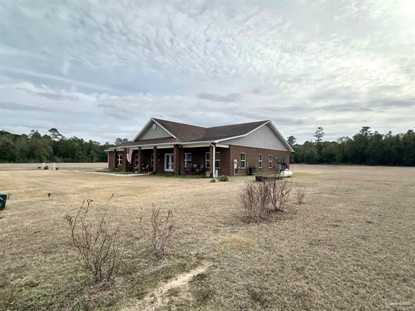 a view of a porch with furniture and a yard