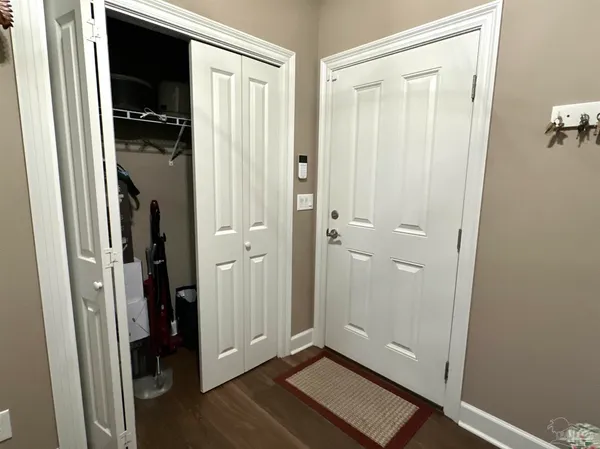 a bathroom with a granite countertop sink a toilet a shower and a mirror