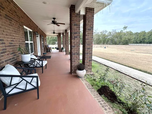 a backyard of a house with table and chairs