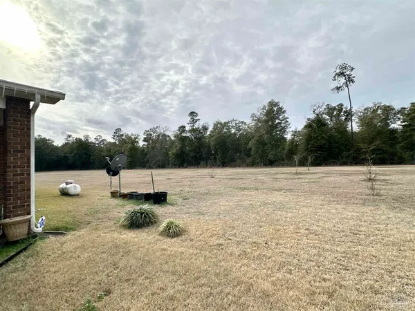 a kitchen with stainless steel appliances kitchen island granite countertop a sink a stove a refrigerator and chairs