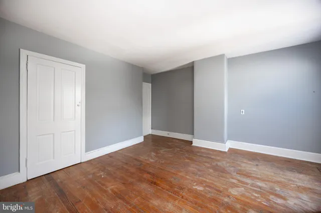 a view of an empty room and wooden floor