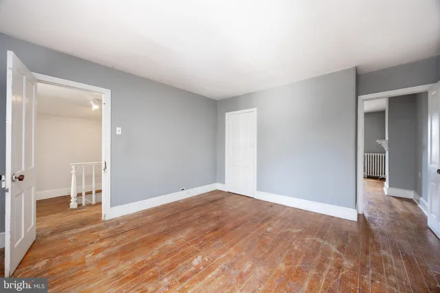 a view of an empty room and wooden floor