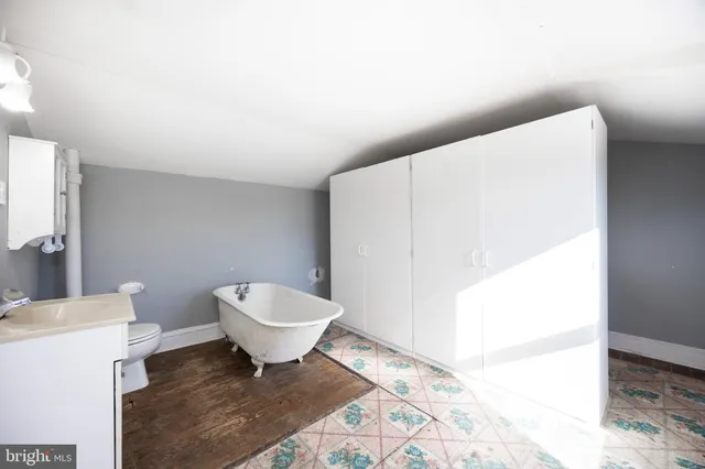 a bathroom with a toilet a sink and mirror