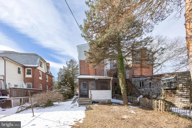 a view of a house with a yard covered in snow