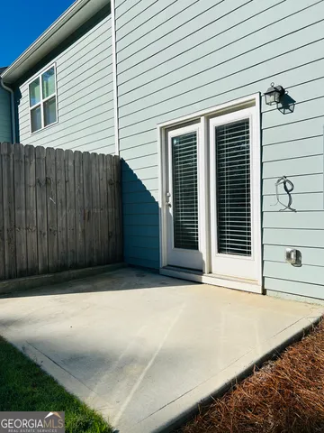 a swimming pool with a bench and trees in the background
