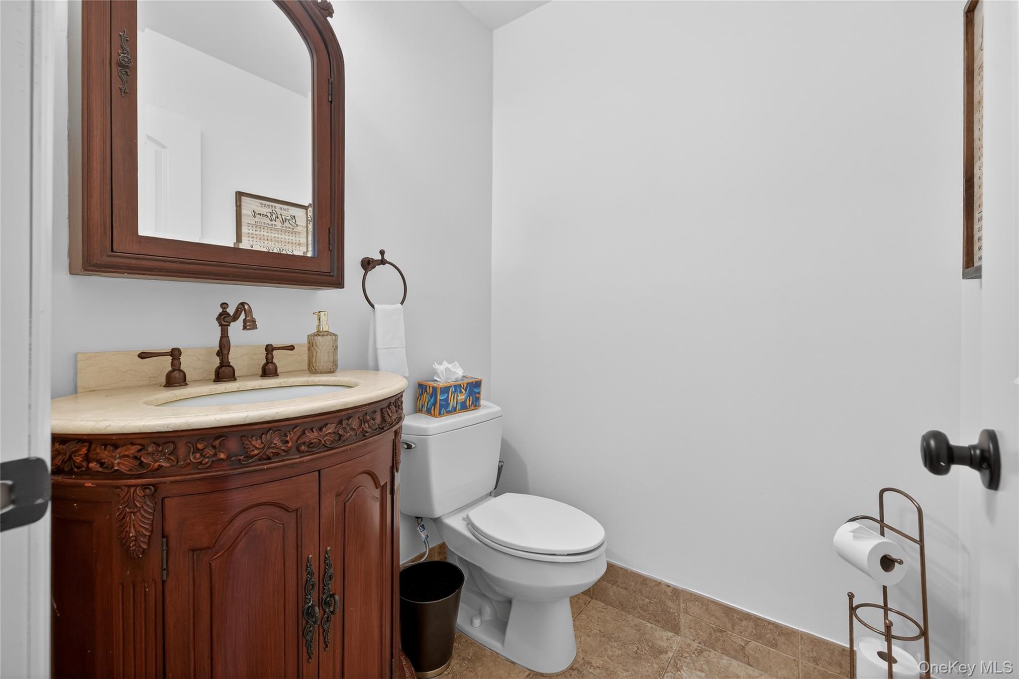 53 Timber Ridge Drive Commack, NY 11725 - Photo 13 of 50 a bathroom with a toilet a sink and mirror