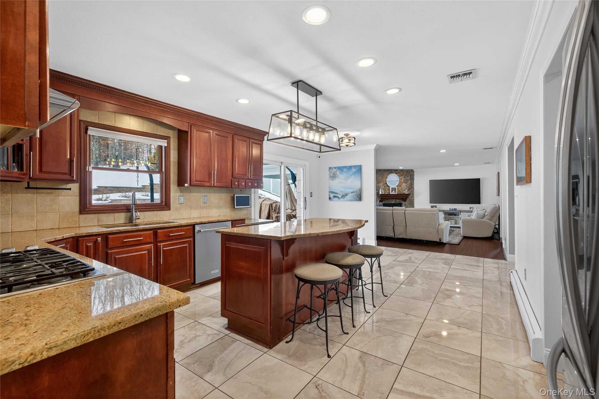 53 Timber Ridge Drive Commack, NY 11725 - Photo 17 of 50 a kitchen with cabinets and chairs