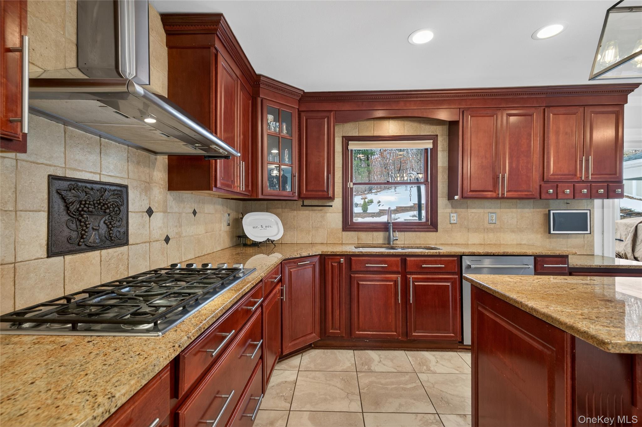 53 Timber Ridge Drive Commack, NY 11725 - Photo 18 of 50 a kitchen with stainless steel appliances granite countertop a stove a sink and a microwave