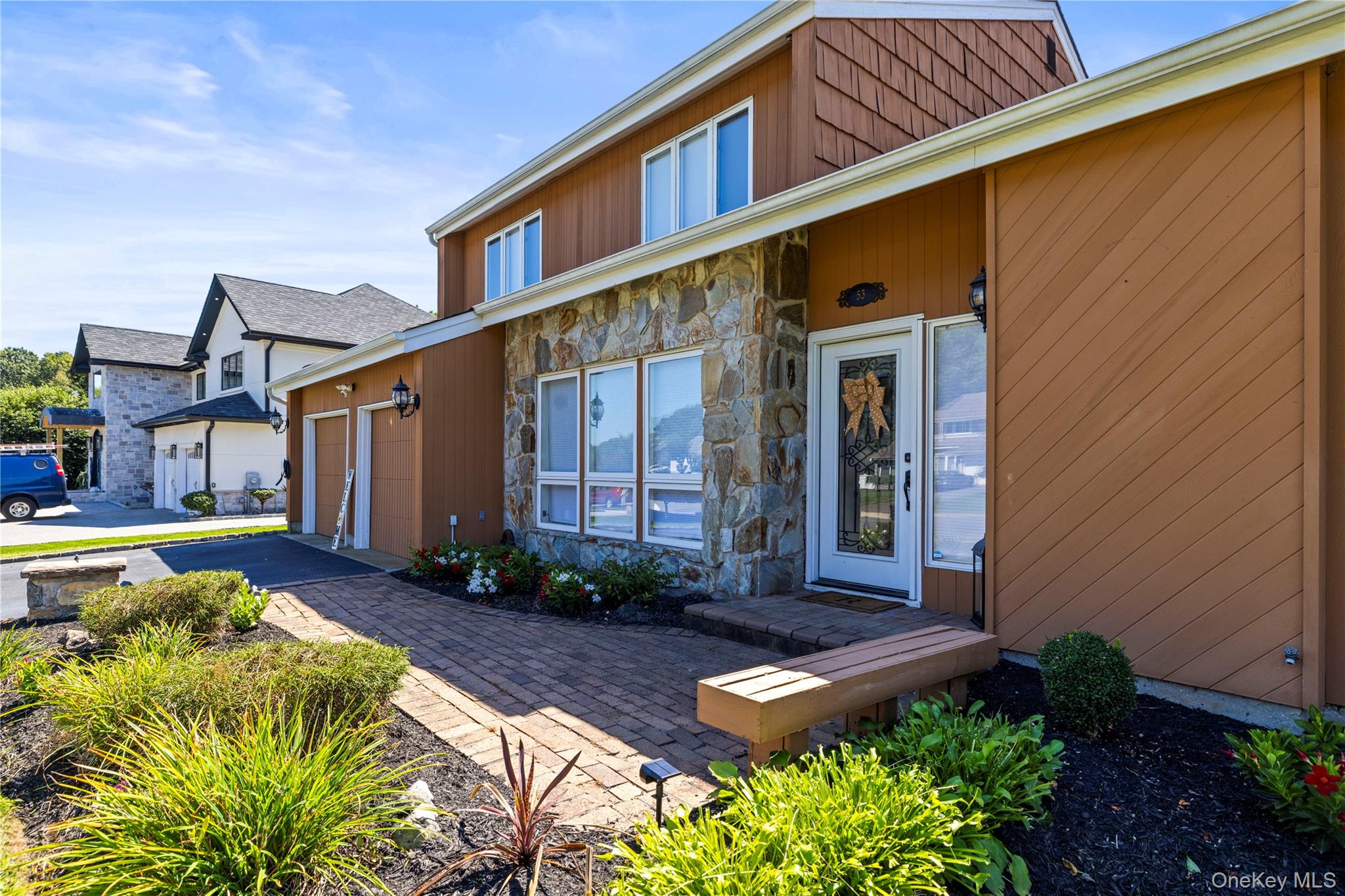 53 Timber Ridge Drive Commack, NY 11725 - Photo 2 of 50 a front view of a house with garden