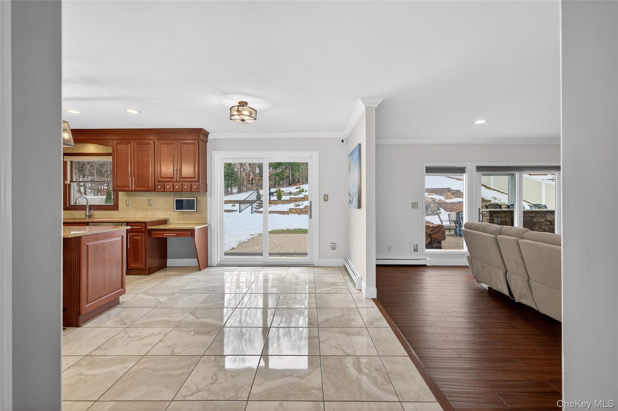 53 Timber Ridge Drive Commack, NY 11725 - Photo 21 of 50 a large kitchen with stainless steel appliances a stove a sink dishwasher a refrigerator and a dining table with wooden floor