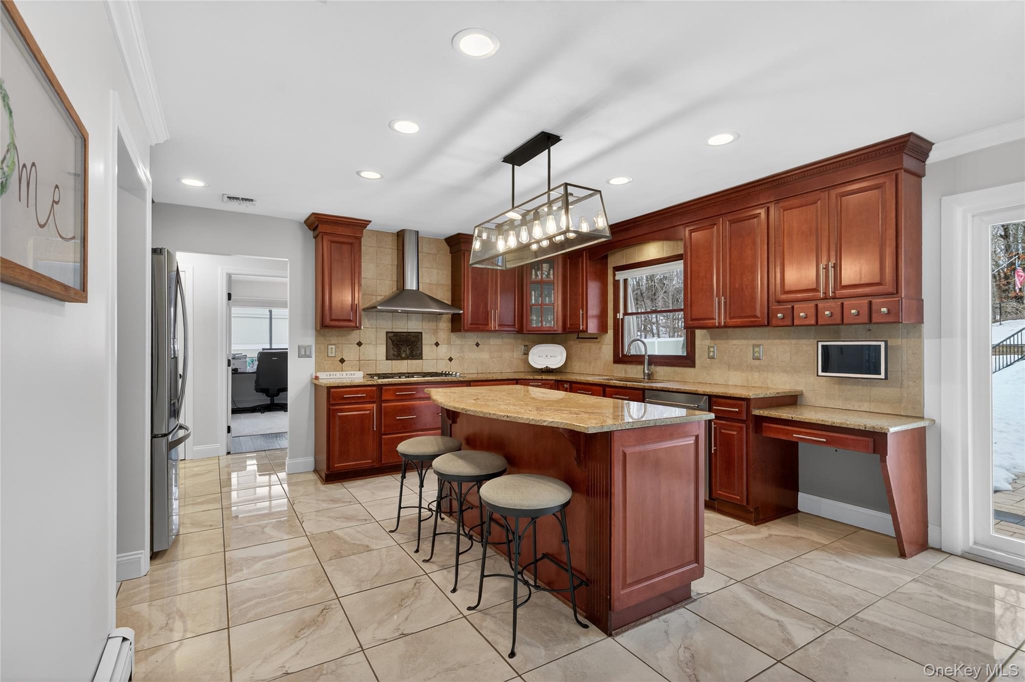 53 Timber Ridge Drive Commack, NY 11725 - Photo 23 of 50 a kitchen with kitchen island granite countertop wooden cabinets and stainless steel appliances