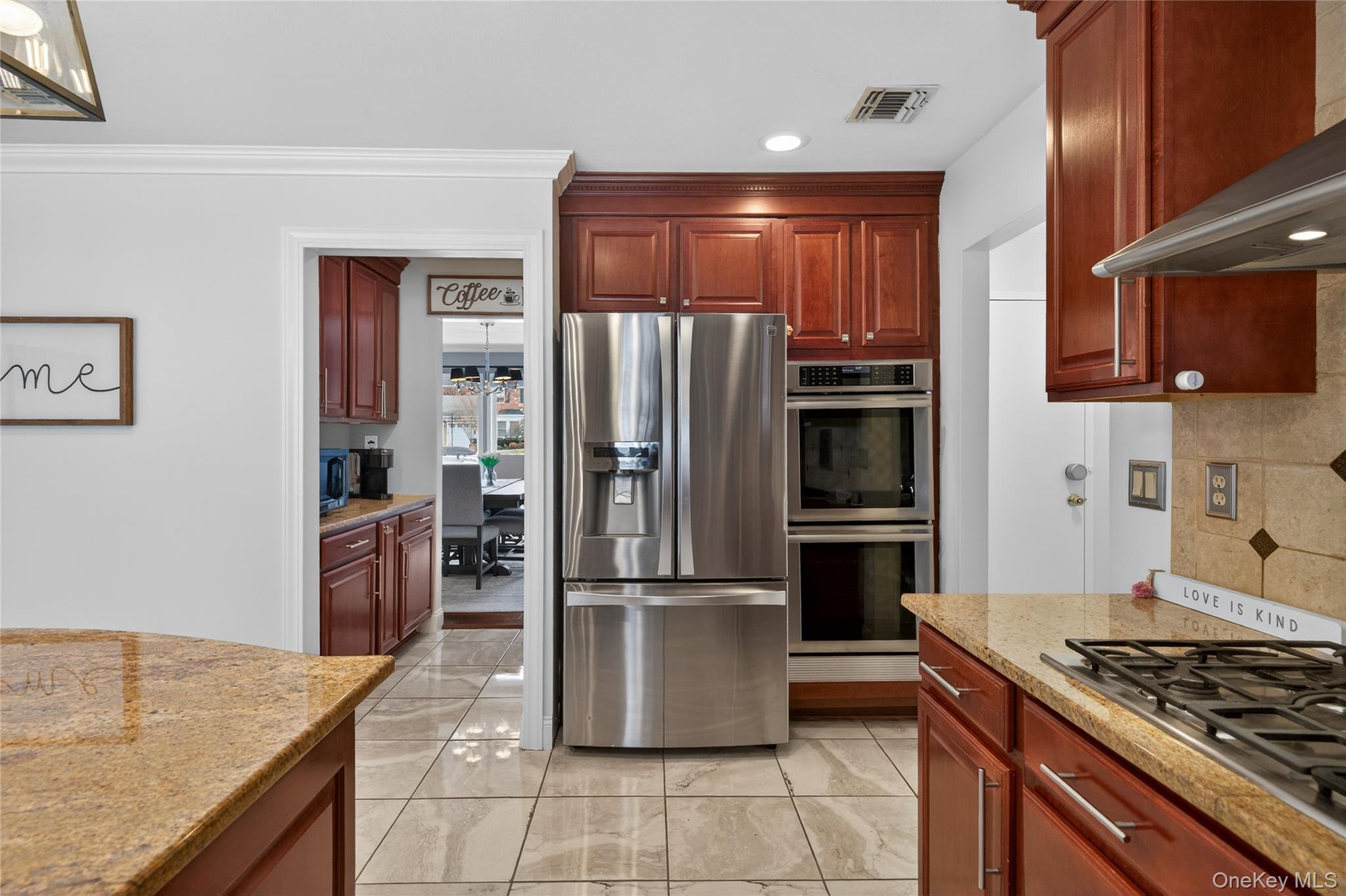 53 Timber Ridge Drive Commack, NY 11725 - Photo 25 of 50 a kitchen with stainless steel appliances granite countertop a refrigerator and a stove