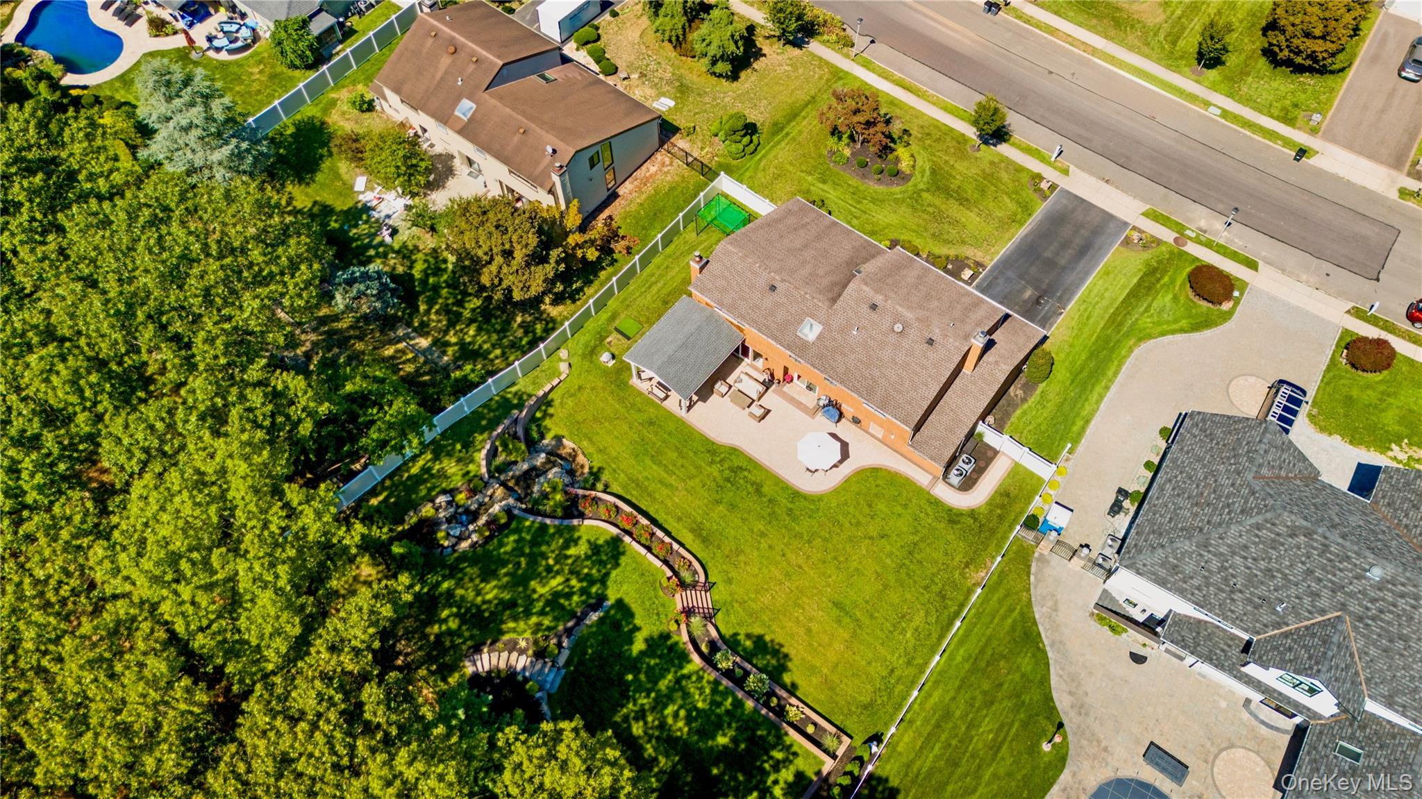53 Timber Ridge Drive Commack, NY 11725 - Photo 3 of 50 an aerial view of a house with a swimming pool