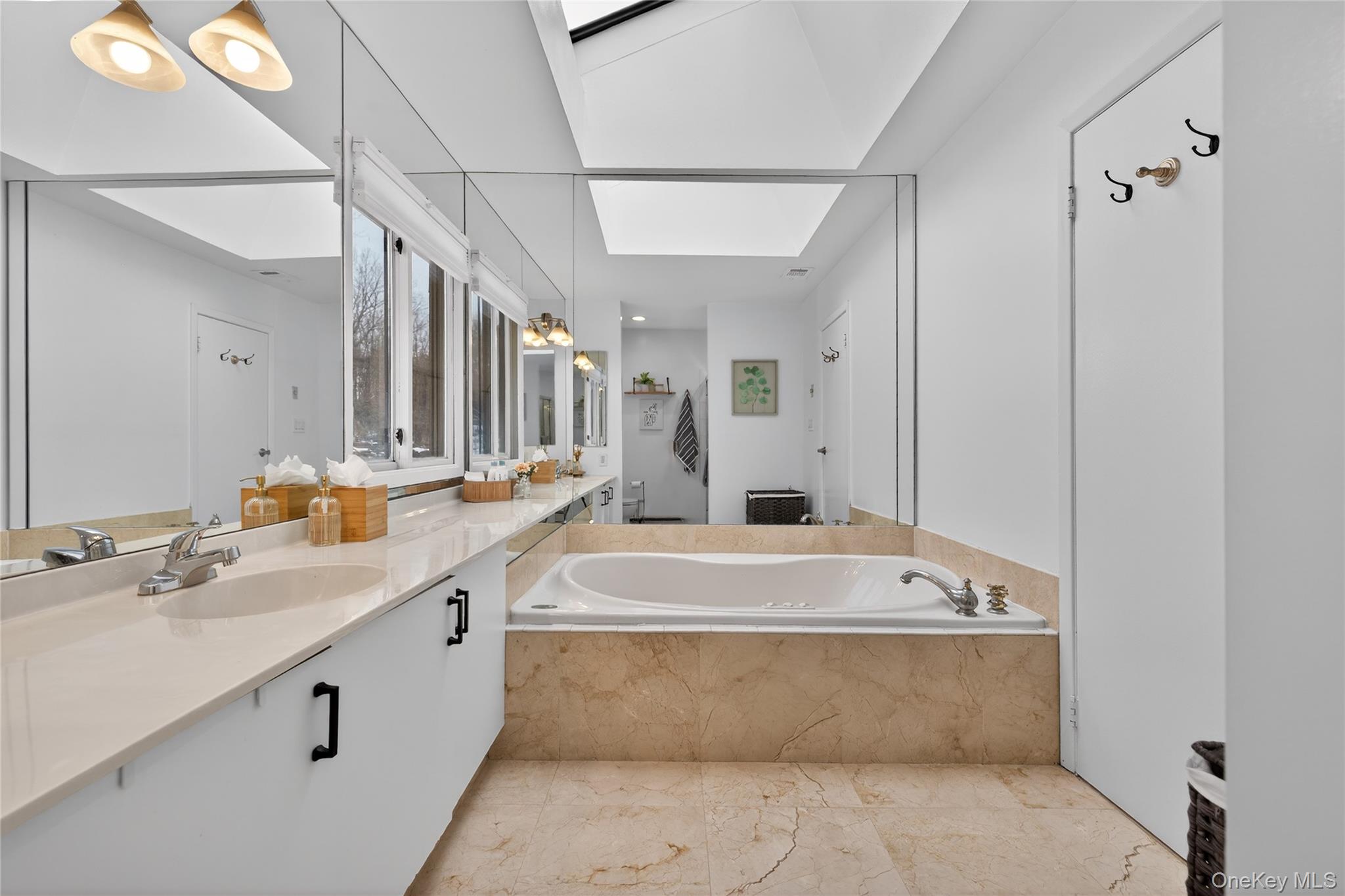 53 Timber Ridge Drive Commack, NY 11725 - Photo 35 of 50 a spacious bathroom with a tub sink and mirror