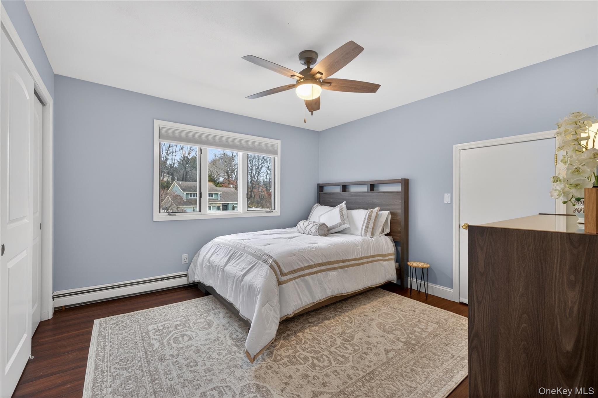 53 Timber Ridge Drive Commack, NY 11725 - Photo 38 of 50 a bedroom with a bed and wooden floor