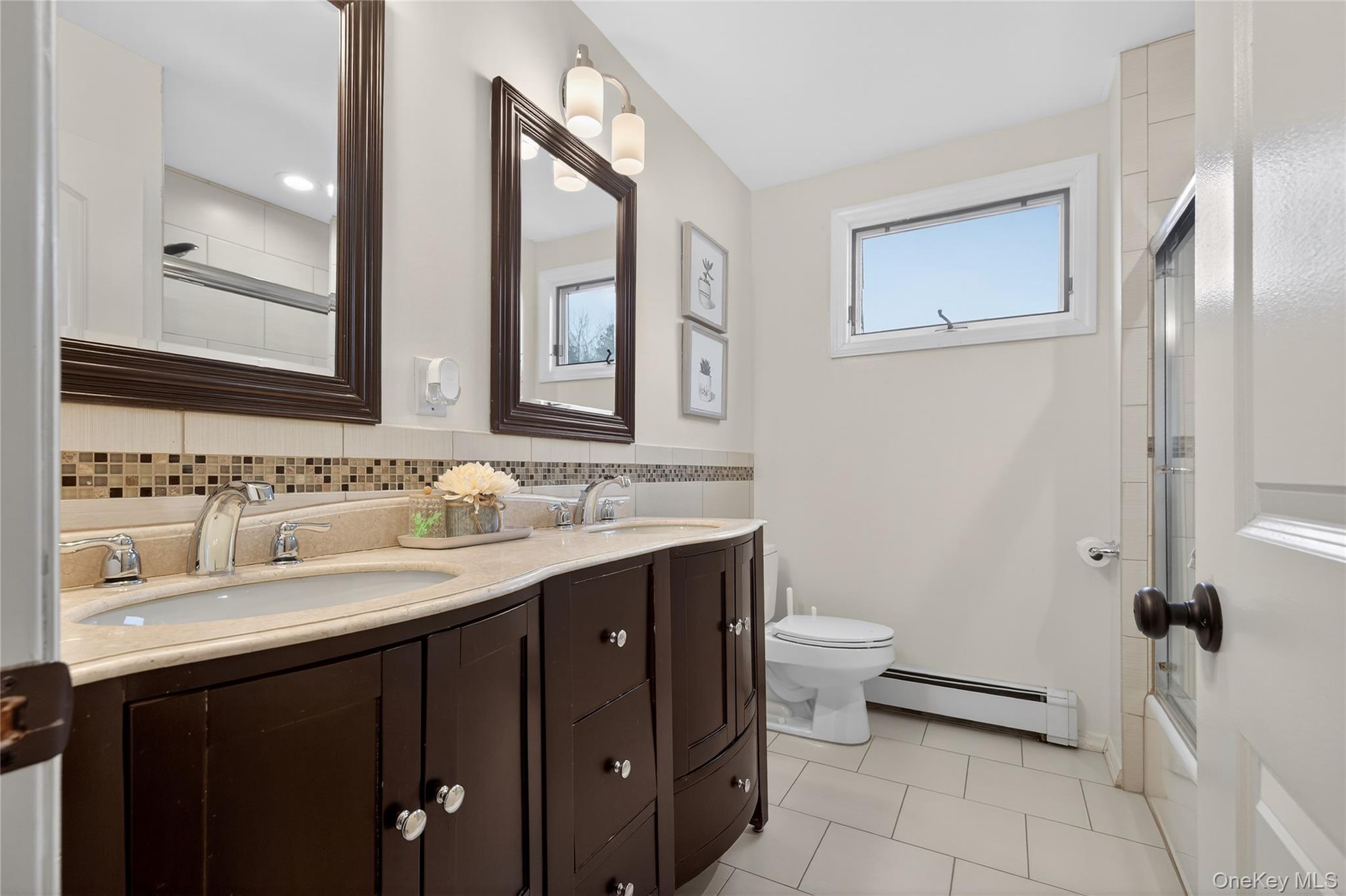 53 Timber Ridge Drive Commack, NY 11725 - Photo 39 of 50 a bathroom with a double vanity sink toilet and a mirror