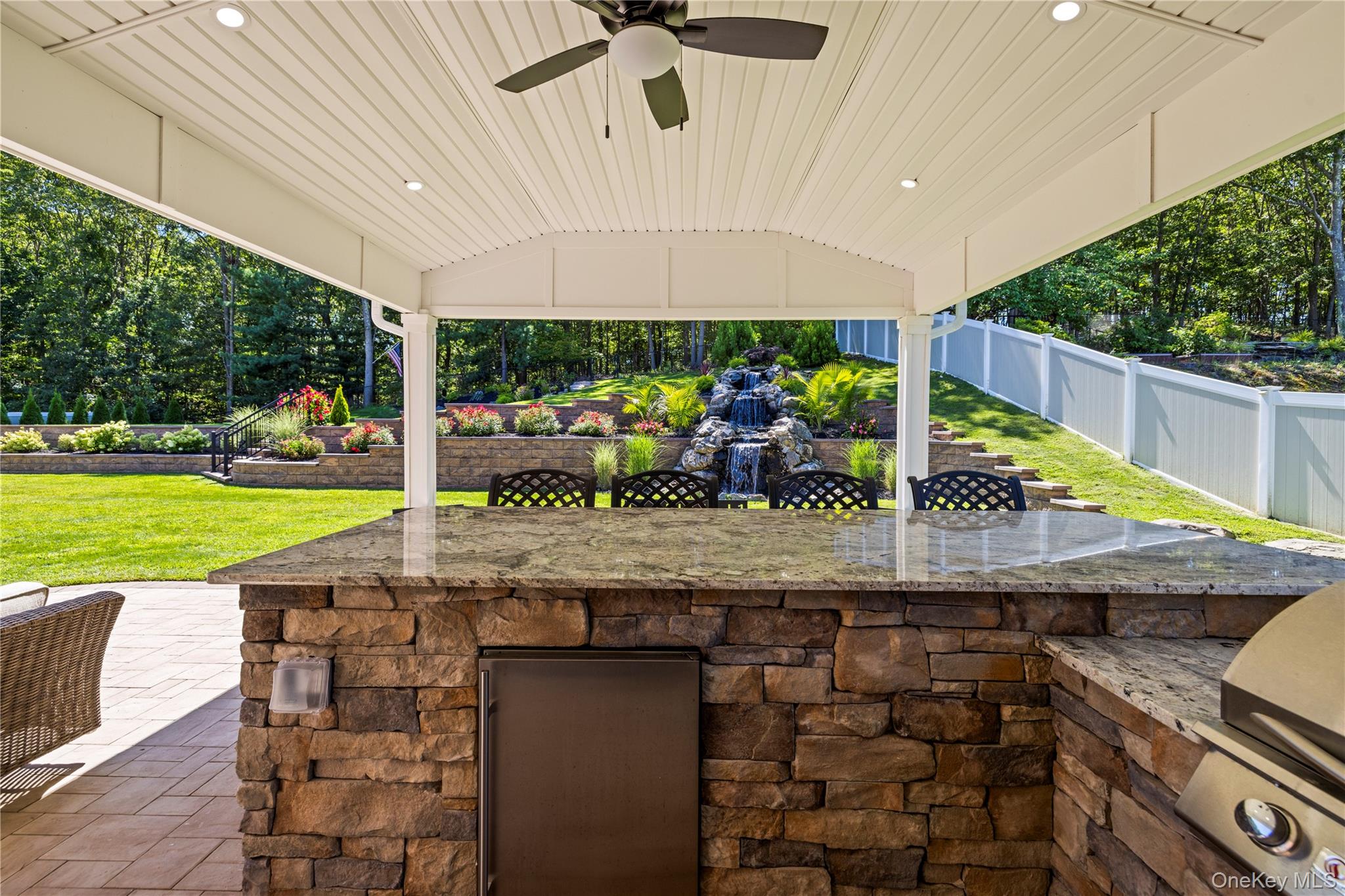 53 Timber Ridge Drive Commack, NY 11725 - Photo 46 of 50 a view of a patio with table and chairs a barbeque with wooden floor and fence