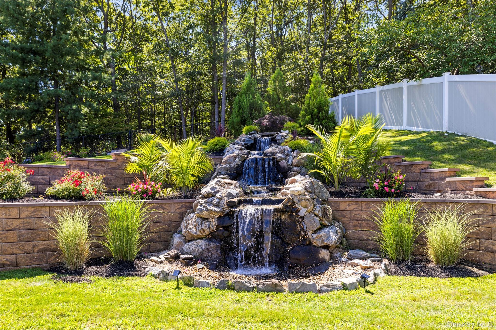 53 Timber Ridge Drive Commack, NY 11725 - Photo 47 of 50 a view of a garden with a fountain