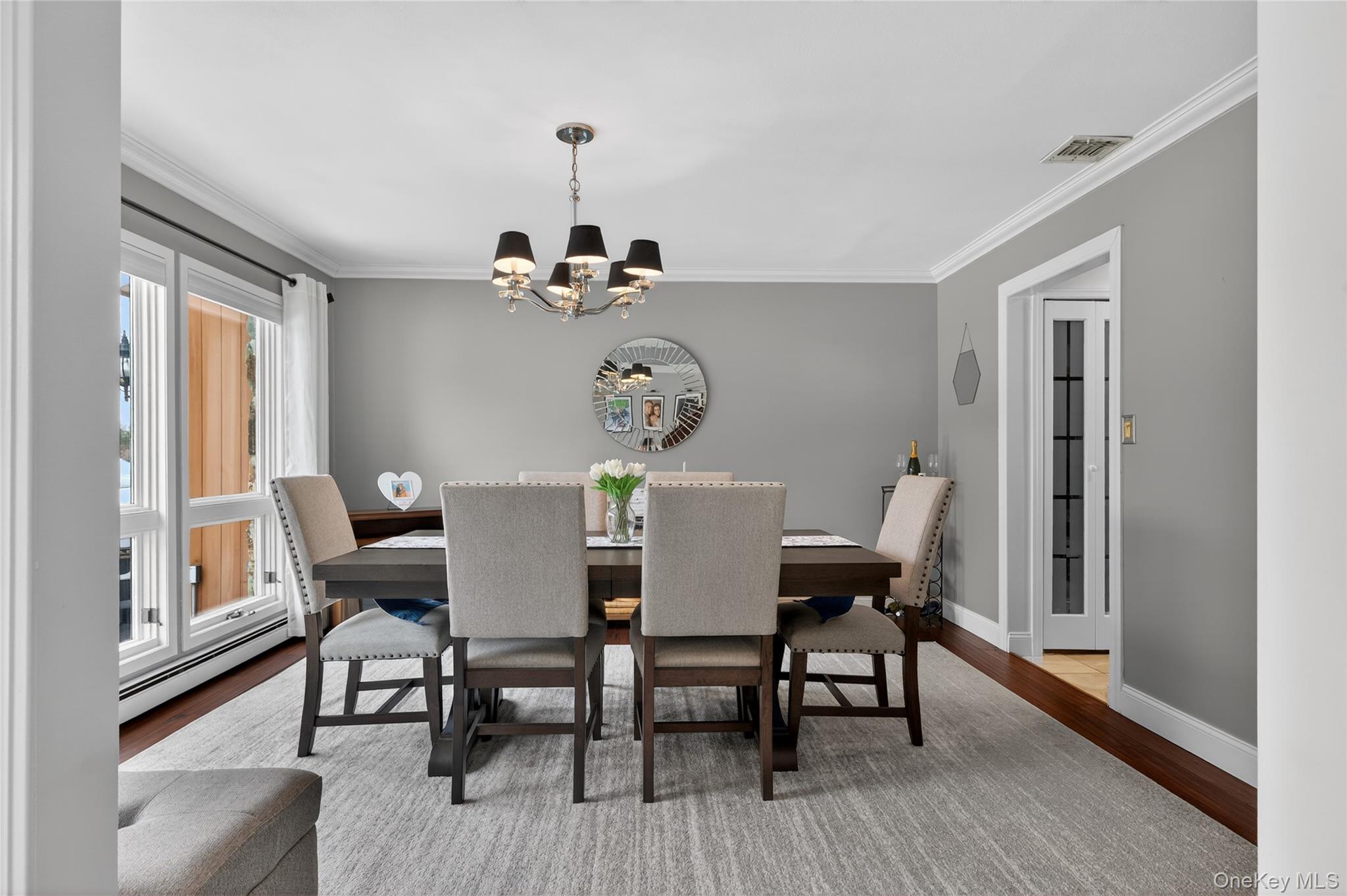 53 Timber Ridge Drive Commack, NY 11725 - Photo 10 of 50 a view of a dining room with furniture a chandelier and wooden floor