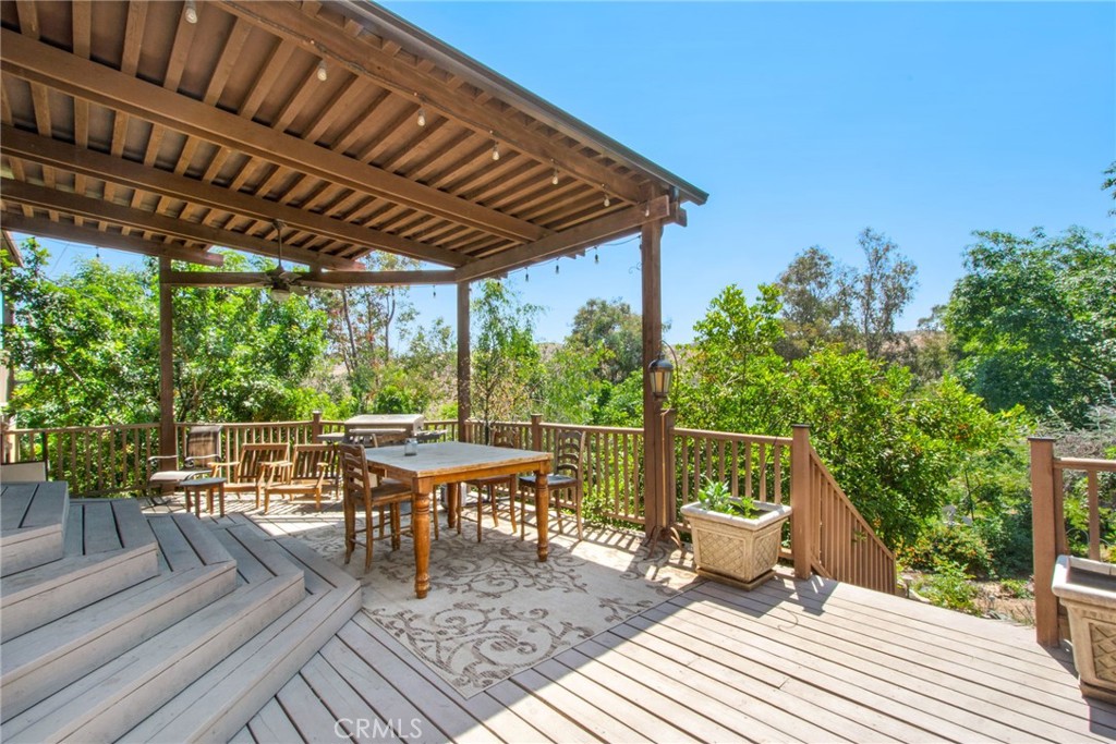7241 Old Temescal Road Corona, CA 92881 - Photo 22 of 47 a roof deck with table and chairs and potted plants with wooden floor